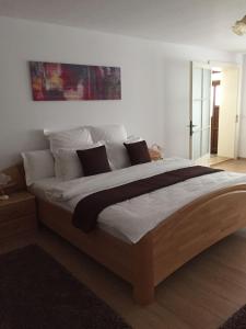 a bedroom with a large bed with white sheets and pillows at Xenopol Central in Sibiu