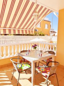 a patio with a table and chairs on a balcony at Villa Sol Ciudad Quesada in Ciudad Quesada