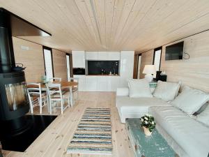 a living room with a white couch and a stove at Waterfront Loft in Brandenburg an der Havel