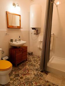 a bathroom with a sink and a toilet and a tub at Heltau Apartments in Cisnădie +30 photos