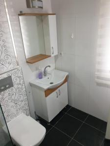 a small bathroom with a sink and a toilet at AQUA CİTY SUİT in Antalya