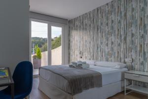 Postel nebo postele na pokoji v ubytování Hospedium Apartamentos Galitrips A Casa Da Reina