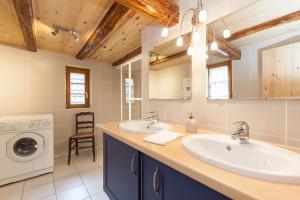 ein Badezimmer mit 2 Waschbecken und einer Waschmaschine in der Unterkunft Gîte Bei der Kirche 4 étoiles in Mundolsheim