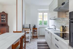 une cuisine avec des placards blancs et un comptoir dans l'établissement Casa vacanza Massa, à Massa
