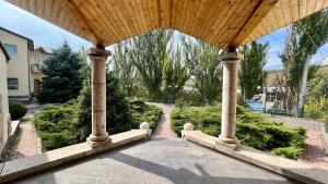an outdoor porch with a wooden roof and a walkway at Aquapark Hotel & Villas in Yerevan