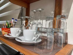 a shelf with cups and glasses on it at Château NaNa Willine in Accra