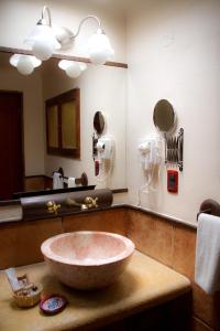 a bathroom with a large bowl sink in front of a mirror at Casa de los Arcángeles in San Cristóbal de Las Casas