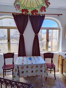 a room with a table and two chairs and a window at Traditional Maltese Townhouse in Rabat in Rabat