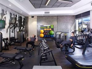 a fitness room with people exercising on treadmills at Cosy Executive Hotel Room (SA) in Johannesburg