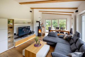 a living room with a couch and a tv at Ferienhaus Chalet Bergblick in Stryck