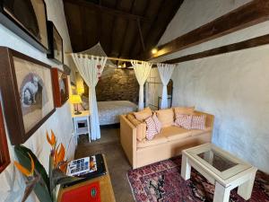 a living room with a couch and a bed at Finca La Principal in Breña Alta