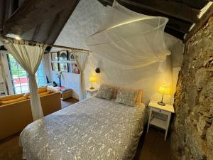 a bedroom with a bed with a mosquito net at Finca La Principal in Breña Alta
