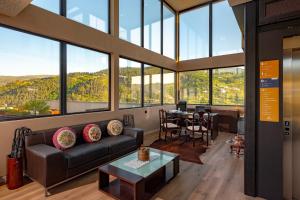 a living room with a couch and a table at Quinta de Cabanas Douro Country House in Penha Longa