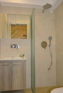 a bathroom with a shower and a sink at Sea Legends in Nea Vrasna +12 photos