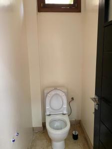 a bathroom with a toilet with the seat up at Riad Targante Takate 1 in Sidi Bibi