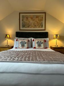 a bedroom with a large bed with two lamps at Beaches in Ayr