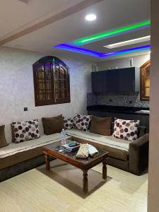 a living room with a couch and a coffee table at Riad Targante Takate 1 in Sidi Bibi