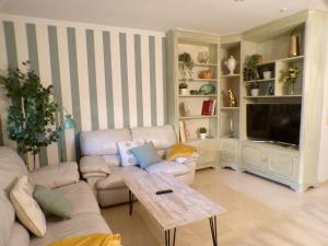 a living room with a couch and a table at Casa MUNDOVALENCIA in Valencia