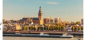 a city with a river and a city with boats at La Colmena Bed & Breakfast in Nijmegen