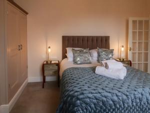 a bedroom with a large bed with two night stands at Abbey Vista in Whitby