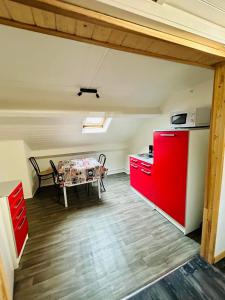a kitchen with a red refrigerator and a table at appartement 2 pieces in Aurillac