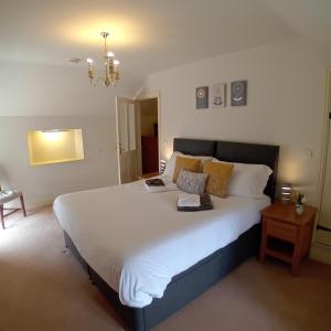 a bedroom with a large bed with white sheets and pillows at Castle Court in York