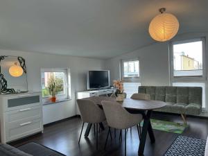 a living room with a table and a couch at House Susanne in Cologne