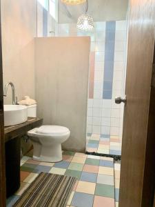 a bathroom with a toilet and a sink at 940 Dahlia near Daang Hari in Manila +5 photos