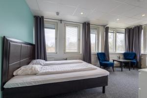Säng eller sängar i ett rum på Stockholm Hotel Apartments Sollentuna