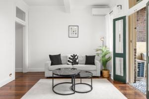 a living room with a couch and a table at Perfect 2BR Harbour View Apartment in Sydney +40 photos