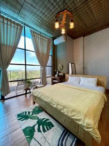 a bedroom with a large bed and a large window at Sea Urchin Homestay in Phan Rang–Tháp Chàm