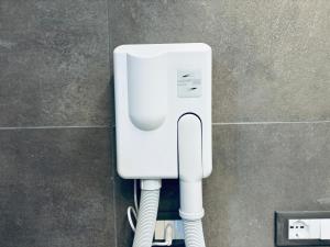 a white soap dispenser on a wall in a bathroom at Appartamento - Angolo di Rio in Riomaggiore