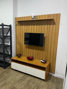 a living room with a television on a wall at Lindo apartamento em Copacabana in Rio de Janeiro