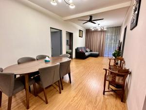 a living room with a dining room table and a couch at Emerald Avenue Brinchang Muji style in Brinchang +31 photos
