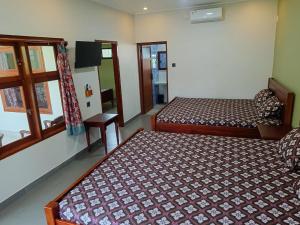 Ένα ή περισσότερα κρεβάτια σε δωμάτιο στο Mango Guesthouse