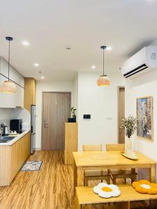 a kitchen and dining room with a table and chairs at Vinhomes Grandpark homestay Du’s Happy in Gò Công