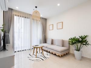 a living room with a couch and a table at Vinhomes Grandpark homestay Du’s Happy in Gò Công +51 photos