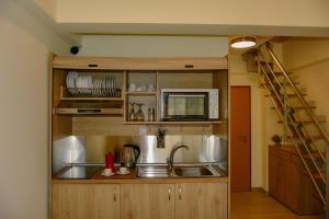a kitchen with a sink and a microwave at Sea Legends in Nea Vrasna