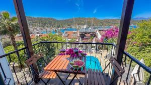 a wooden table with flowers on a balcony at Mykonut Boutique Suites in Fethiye