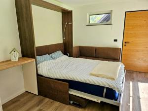 a small bedroom with a bed in a room at Big Windows, Endless Views by Pintar Apartments in Bohinjska Bela