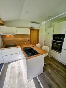 a kitchen with a sink and a counter top at Big Windows, Endless Views by Pintar Apartments in Bohinjska Bela