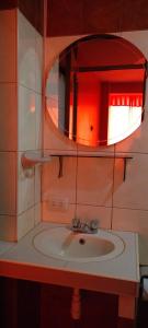 a bathroom with a sink and a mirror at ANDENES DEL TITICACA in Puno