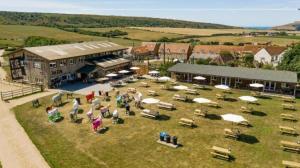 a group of people standing in front of a building at 8 Dragon Fly Den, Camp Tapnell in Yarmouth