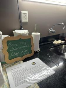 a kitchen counter with a sink and a sign on it at SOMBRAS DEL PARANA Apart Misiones in Eldorado