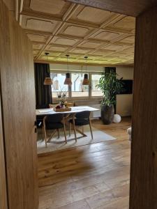 a living room with a table and a dining room at Haus Egger in Jochberg +29 photos