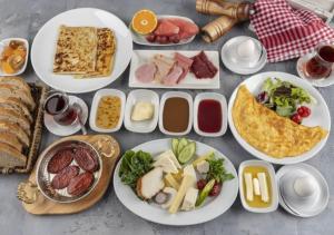 a table full of plates of food with different types of food at Janus Cappadocia Hotel in Nevsehir