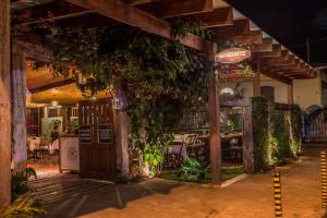 a restaurant with a bunch of plants on the wall at Hotel Bandeirantes - Unidade Centro in Cachoeira do Campo