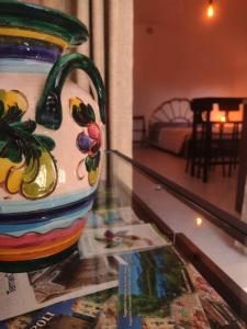 a colorful vase sitting on top of a glass table at Monò in Popoli +19 photos