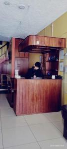 a man sitting at a counter in a kitchen at PUNO ANDENES Suite in Puno