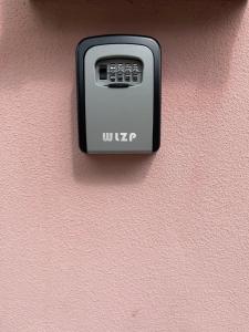 a device on the side of a pink wall at Alba & Tramonto in Levanto